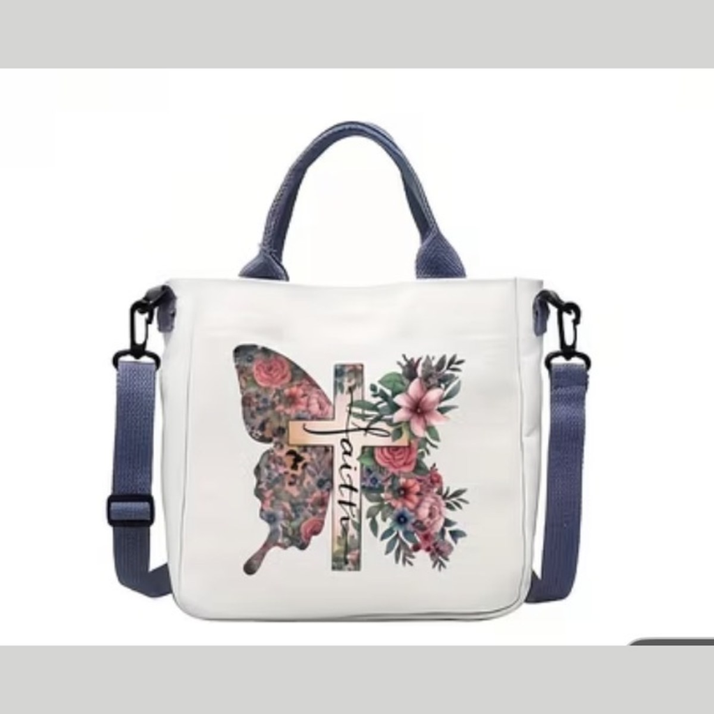 White handbag with a butterfly and floral cross Faith design and navy blue handles and strap