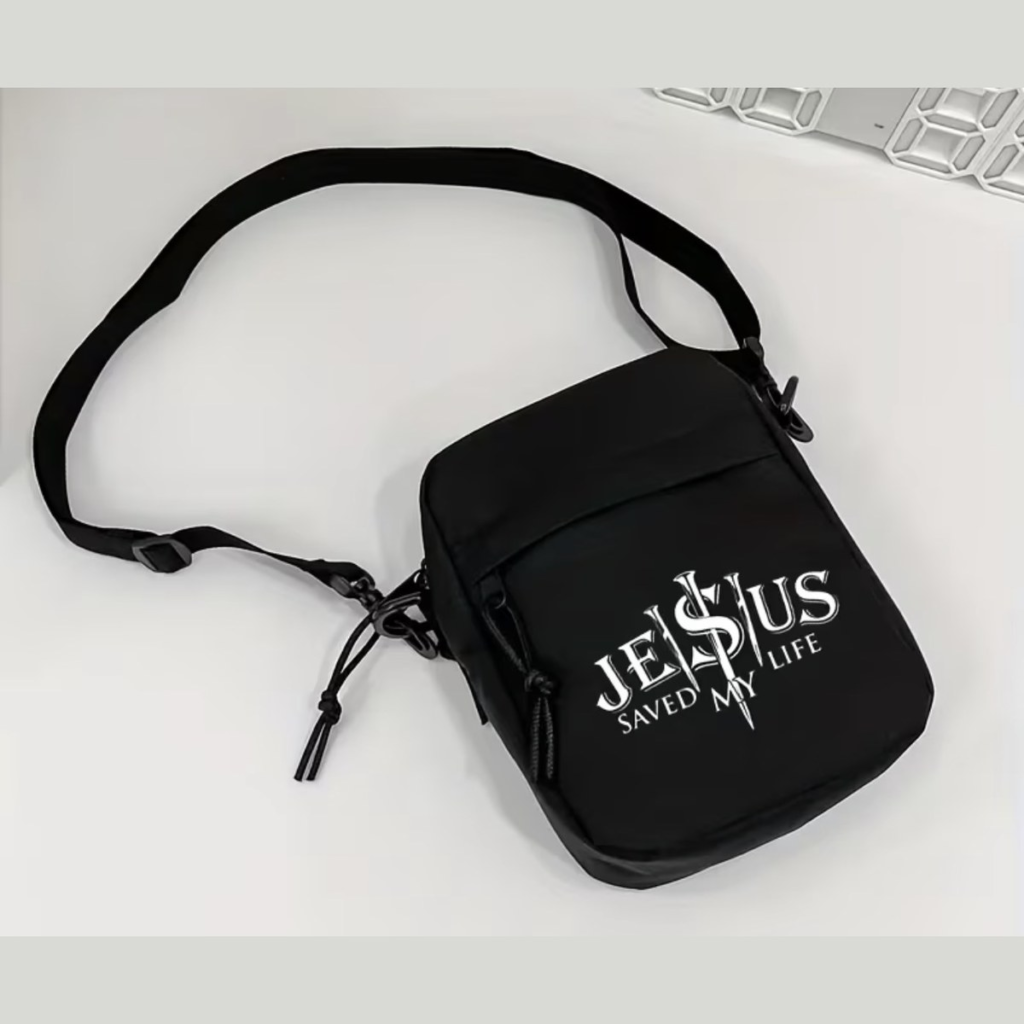Black crossbody bag printed with Jesus Saved My Life in white lettering